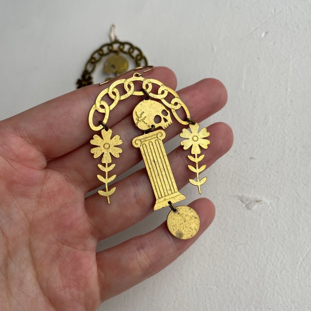 while odin sleeps brass "adventum" skull pedestal dangle earrings